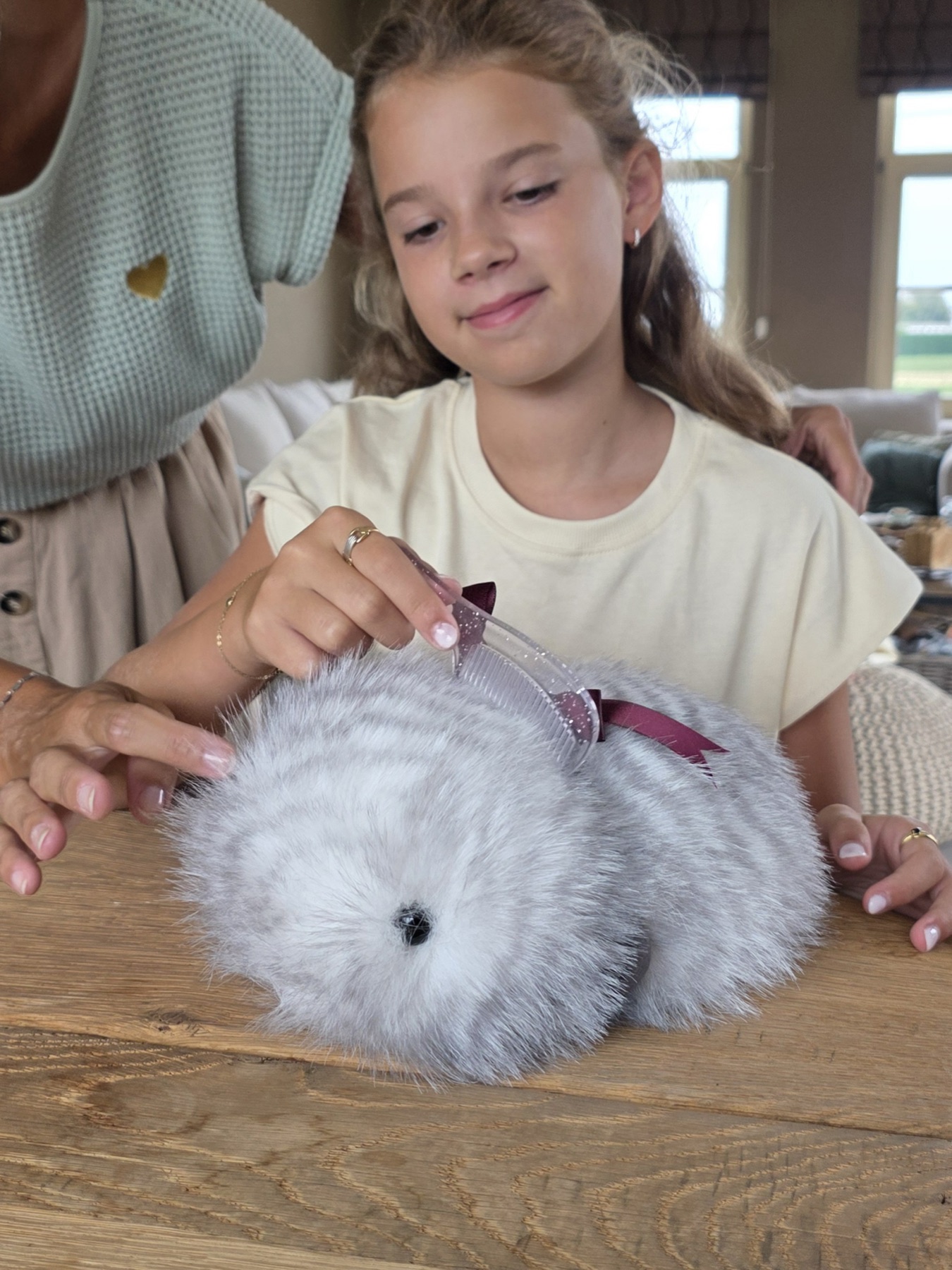 Child gently looks after Cupboo at home